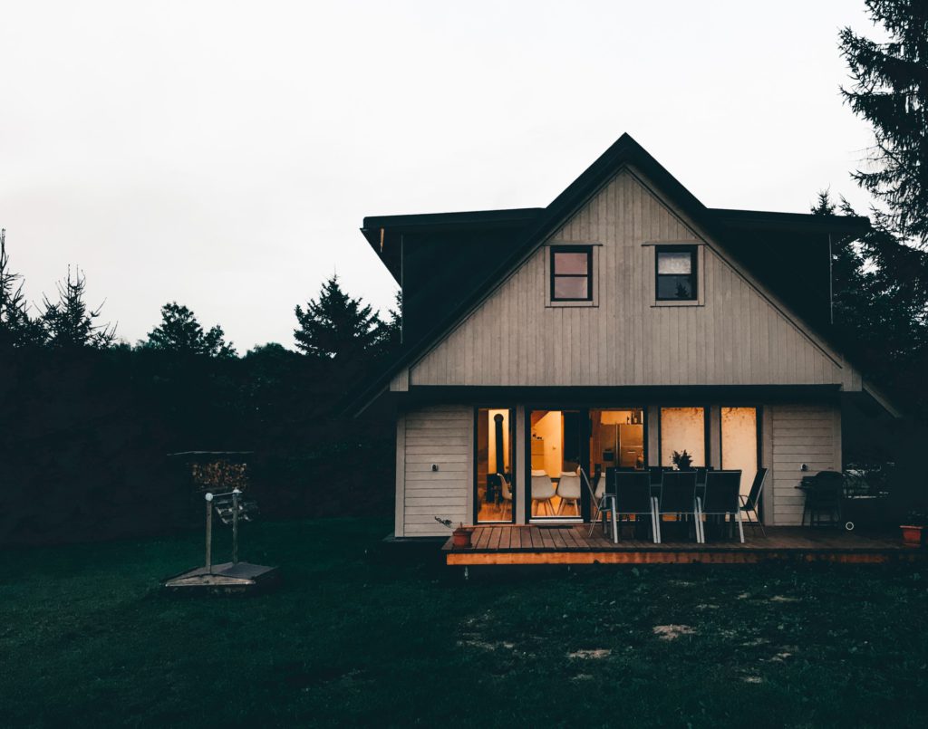 trees beside brown wooden house