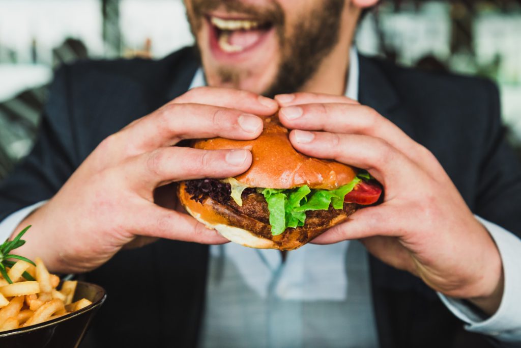 person holding burger