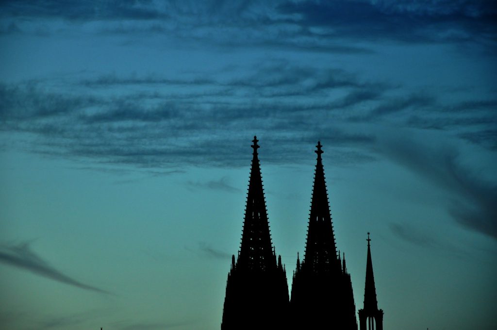 Silhouette of tower under cloudy sky