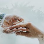 Two hands holding each other isolated in white background