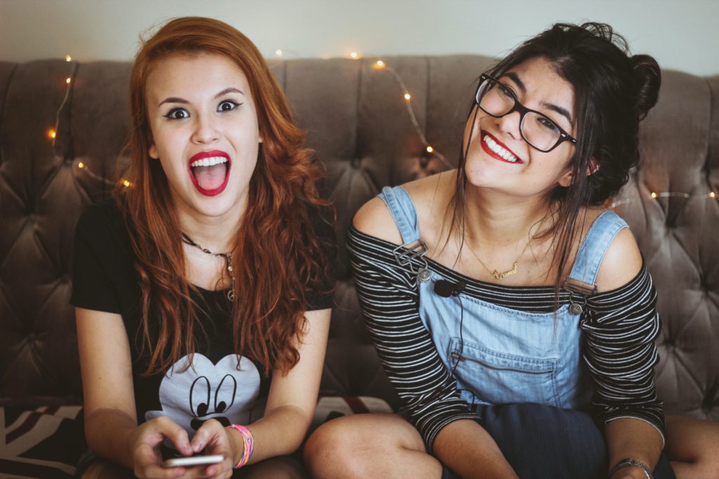 Woman laughing beside woman smiling