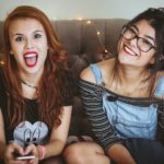 Woman laughing beside woman smiling