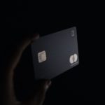 Person holding black card