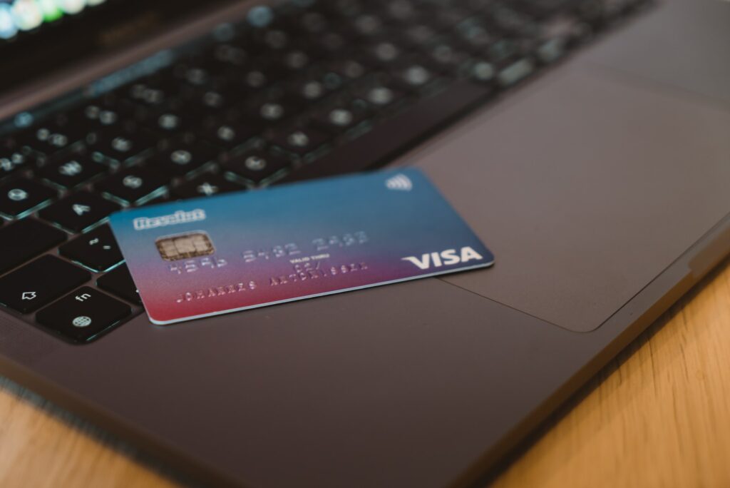 Blue and white visa card on silver laptop computer